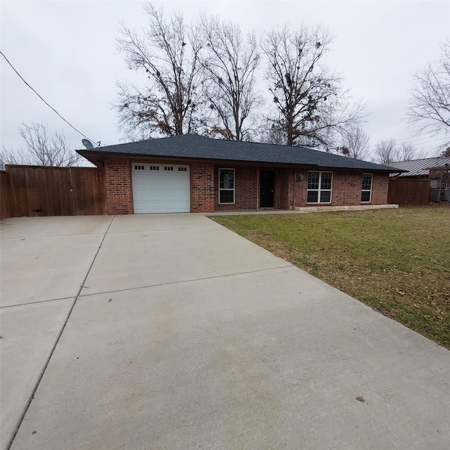 single story home with a garage and a front lawn