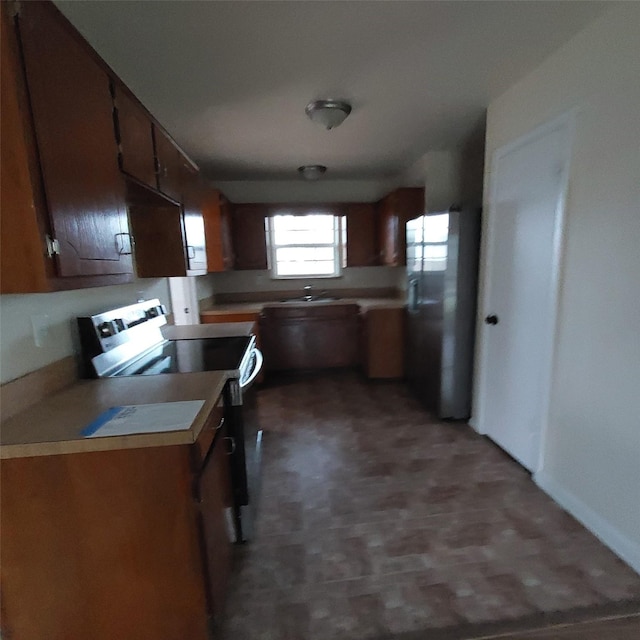 kitchen featuring stainless steel electric stove and sink