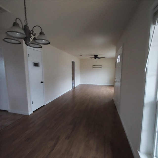 hallway featuring a notable chandelier and dark hardwood / wood-style flooring