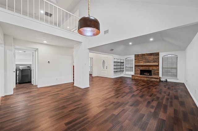 unfurnished living room with a fireplace, dark hardwood / wood-style flooring, and high vaulted ceiling