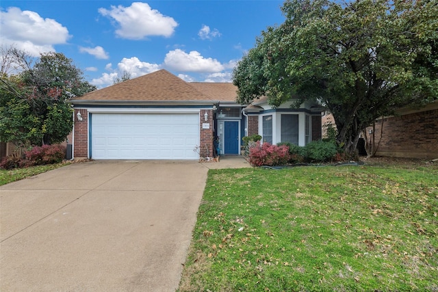 view of front of house featuring a garage and a front lawn