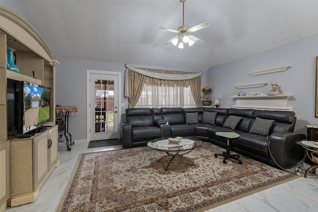 living room with lofted ceiling, a textured ceiling, and ceiling fan