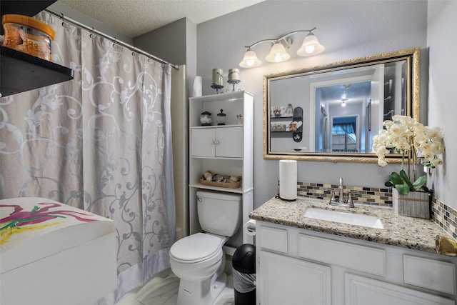 bathroom with backsplash, vanity, walk in shower, toilet, and a textured ceiling