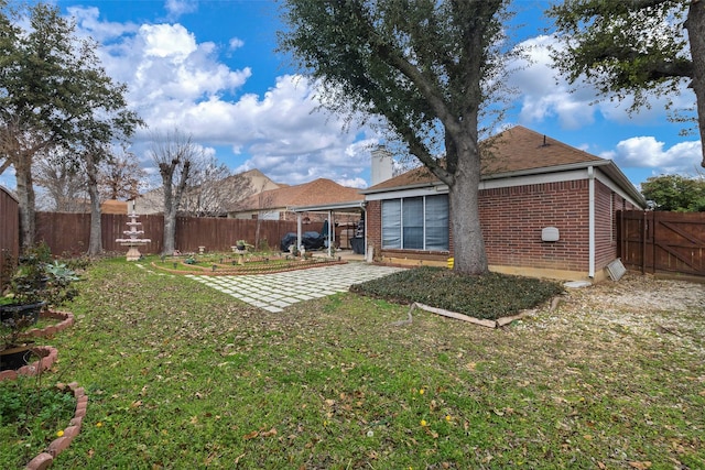 rear view of house featuring a patio area and a lawn