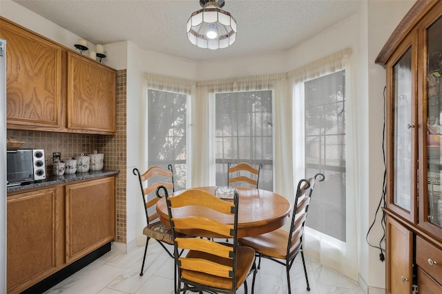 dining space featuring a textured ceiling