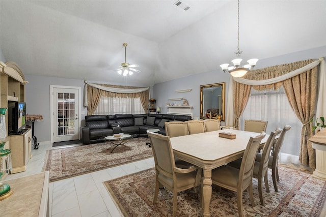 dining area featuring lofted ceiling and ceiling fan with notable chandelier