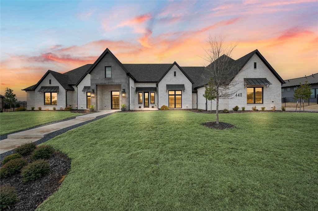 modern inspired farmhouse featuring a yard