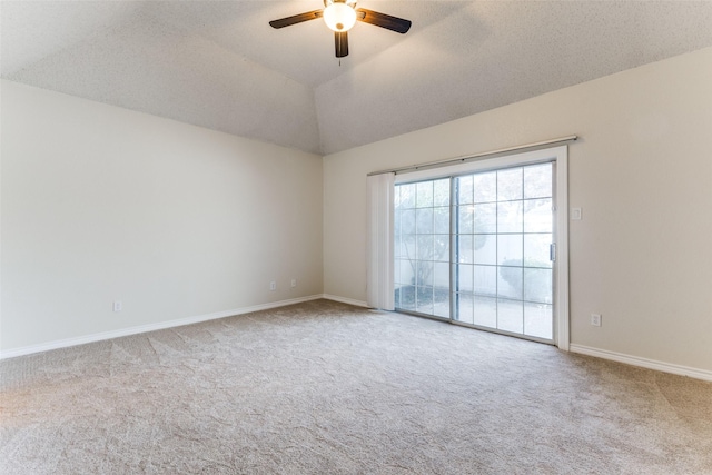 spare room with carpet floors, baseboards, ceiling fan, and lofted ceiling
