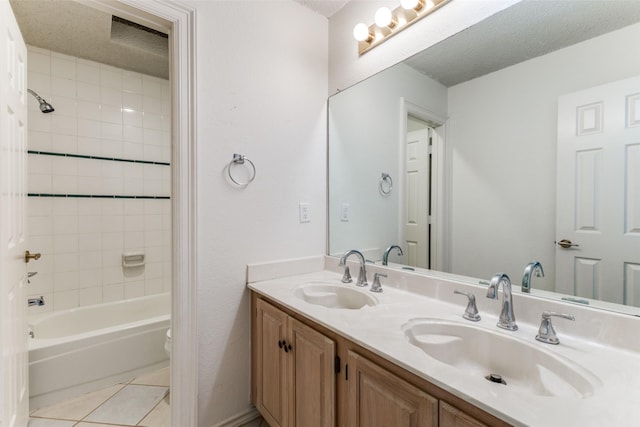 bathroom with double vanity, a sink, washtub / shower combination, and tile patterned flooring