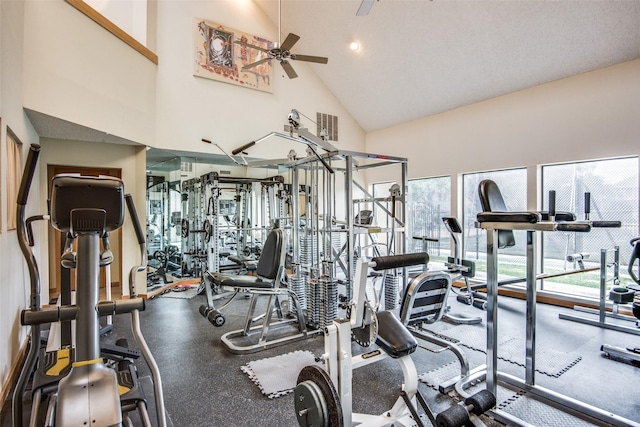 gym with visible vents, ceiling fan, and high vaulted ceiling