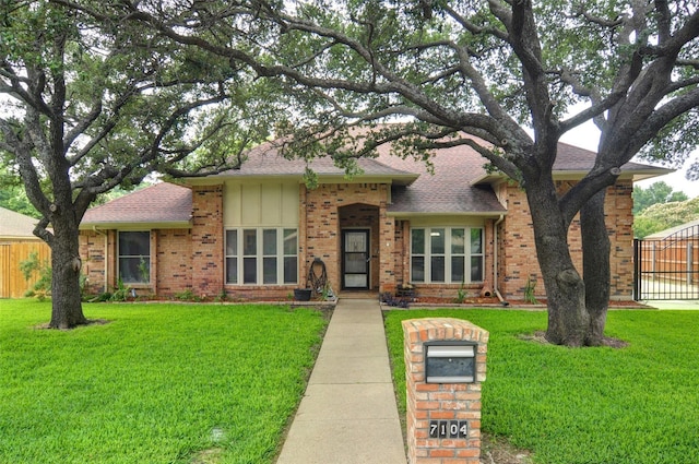 single story home featuring a front lawn