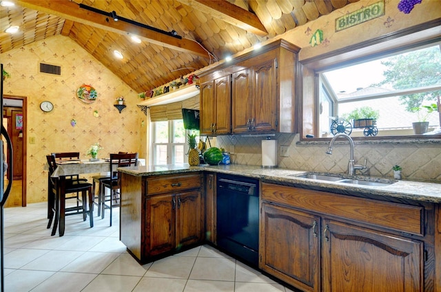 kitchen featuring black dishwasher, lofted ceiling with beams, a sink, and visible vents