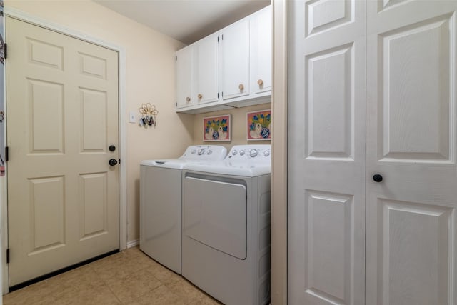 clothes washing area featuring cabinets, washing machine and dryer, and light tile patterned floors