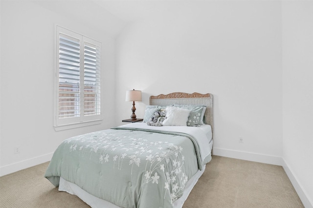 bedroom featuring light colored carpet