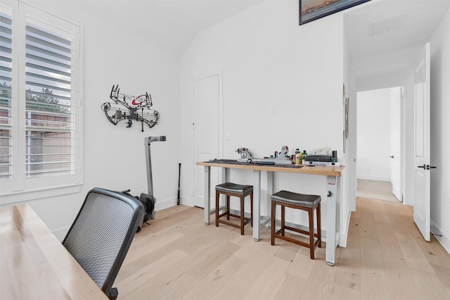 home office with light hardwood / wood-style floors