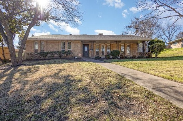 ranch-style home featuring a front yard