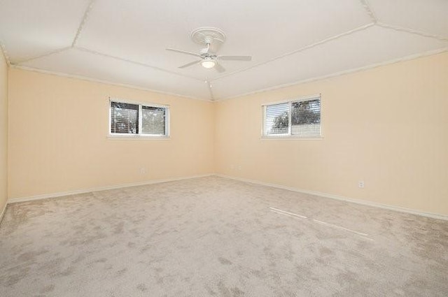 unfurnished room featuring lofted ceiling, carpet flooring, and ceiling fan