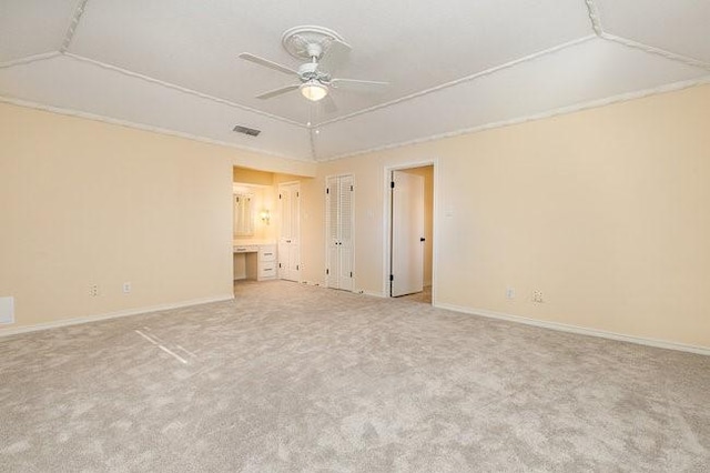 carpeted empty room featuring lofted ceiling and ceiling fan