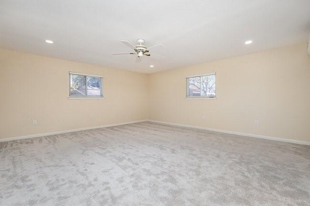 empty room with light carpet, ceiling fan, and a healthy amount of sunlight