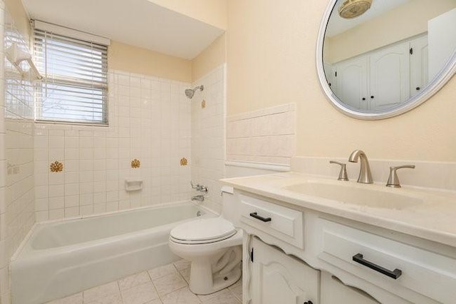 full bathroom with vanity, tile patterned flooring, tiled shower / bath combo, and toilet