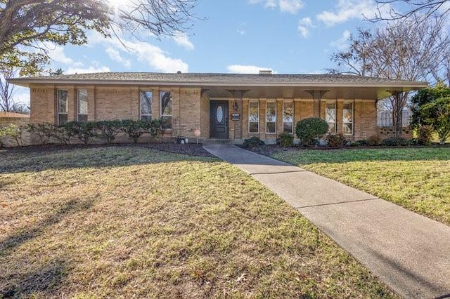 single story home with a porch and a front lawn