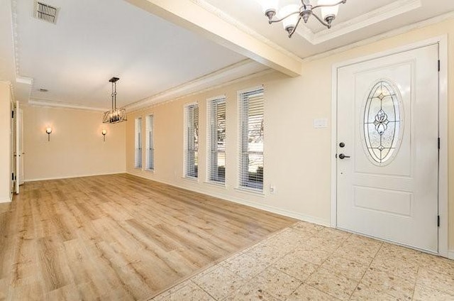 entryway with an inviting chandelier, ornamental molding, and light hardwood / wood-style flooring