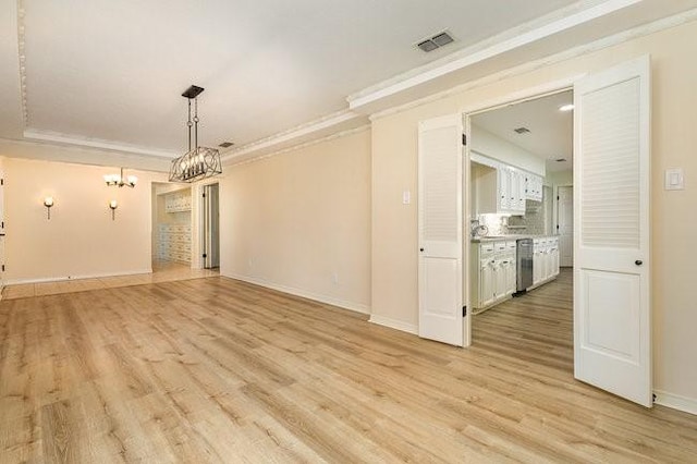 unfurnished dining area featuring crown molding and light hardwood / wood-style floors