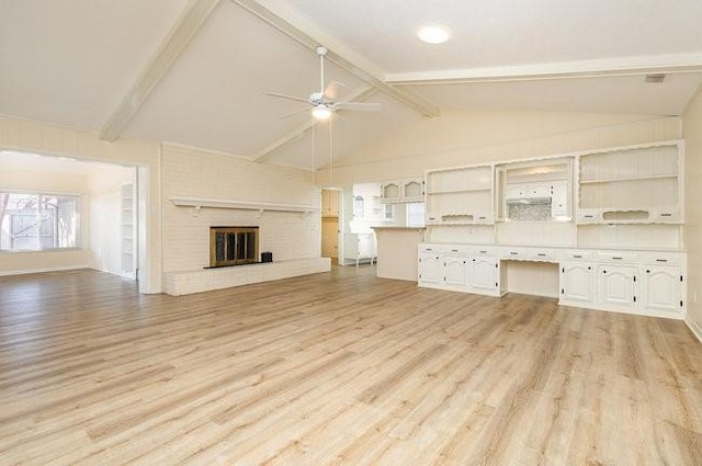 unfurnished living room with ceiling fan, light hardwood / wood-style floors, and vaulted ceiling with beams