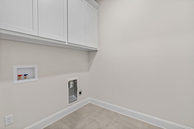 clothes washing area with cabinets, hookup for an electric dryer, and hookup for a washing machine