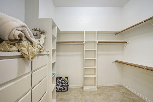 spacious closet with light tile patterned floors