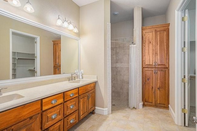 bathroom with vanity, curtained shower, and tile patterned floors