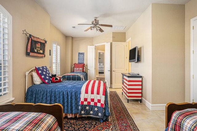 tiled bedroom featuring ceiling fan