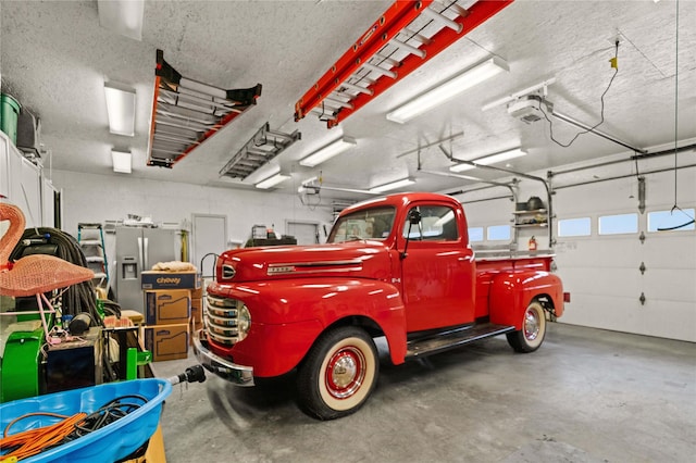 garage with a garage door opener and stainless steel fridge