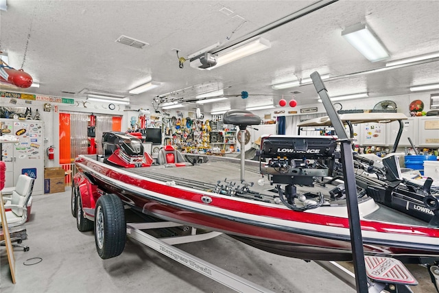 garage with a workshop area, a garage door opener, and white fridge