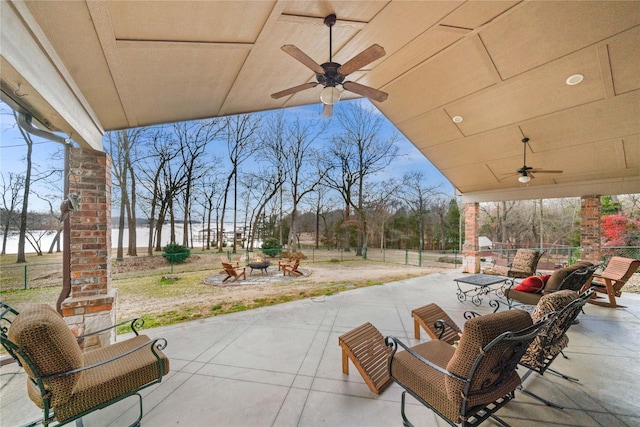 view of patio featuring an outdoor living space, a water view, and ceiling fan