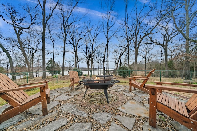 view of patio / terrace featuring a fire pit and a water view