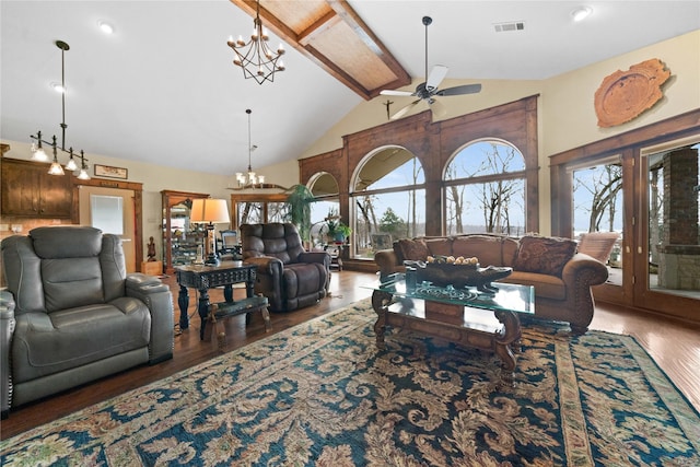 living room with beam ceiling, dark hardwood / wood-style floors, a wealth of natural light, and high vaulted ceiling