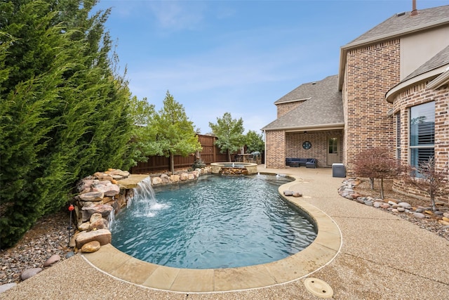 view of pool with a patio area, a fenced backyard, and a pool with connected hot tub