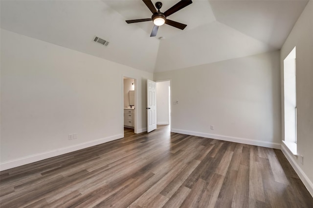 unfurnished bedroom with vaulted ceiling, dark hardwood / wood-style floors, connected bathroom, and ceiling fan