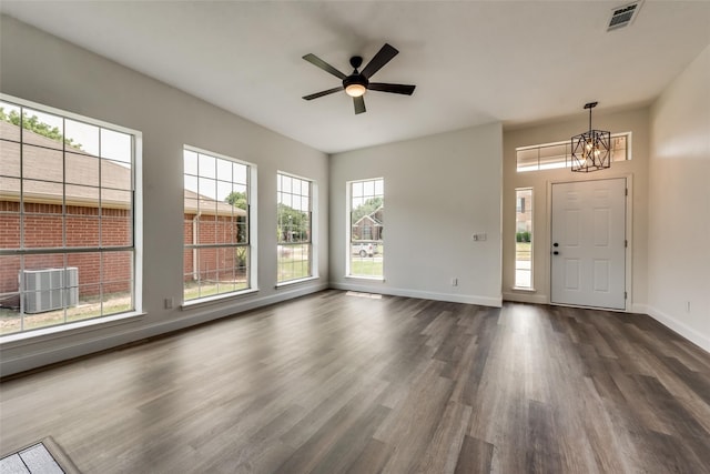 entryway with ceiling fan with notable chandelier and dark hardwood / wood-style floors