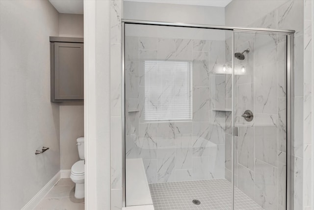 bathroom with an enclosed shower and toilet