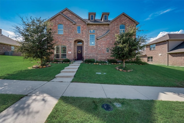 view of property featuring central AC unit and a front yard