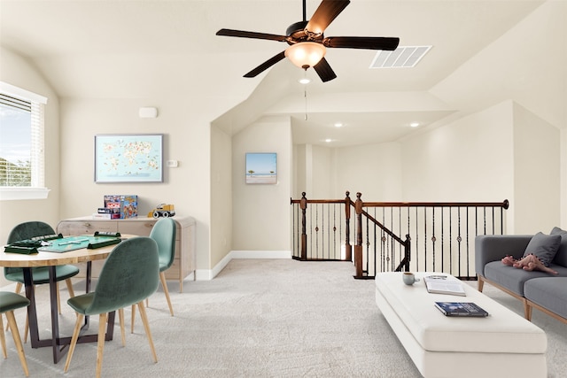 office area with vaulted ceiling, light colored carpet, visible vents, and baseboards