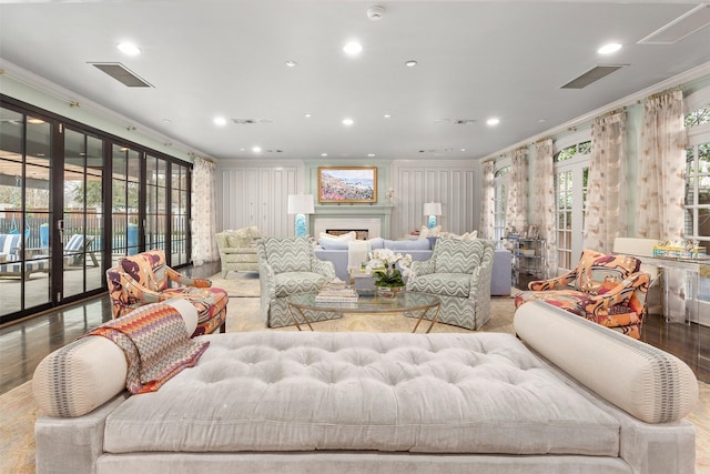 living room with crown molding, french doors, and light hardwood / wood-style flooring