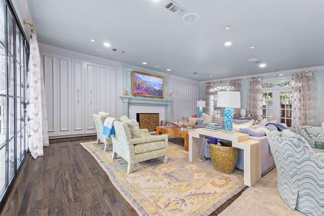 living room with french doors, ornamental molding, and hardwood / wood-style floors