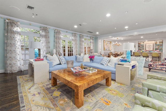 living room with ornamental molding, wood-type flooring, and french doors