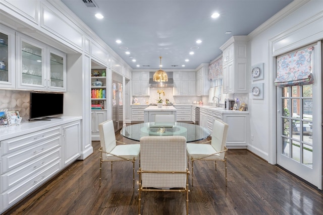 dining room featuring ornamental molding and dark hardwood / wood-style floors