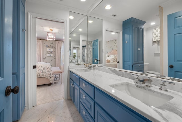 bathroom featuring ornamental molding, vanity, and toilet