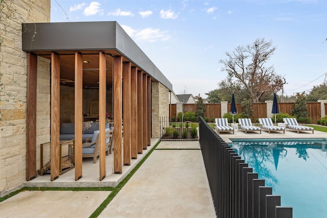 view of swimming pool with a patio