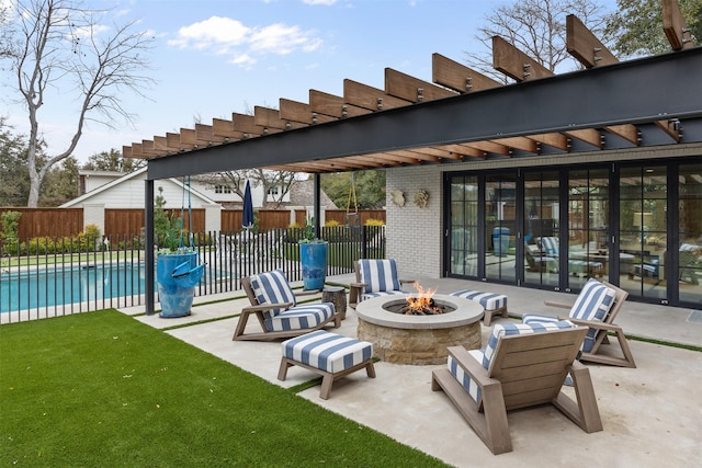 view of patio featuring a fenced in pool and an outdoor fire pit